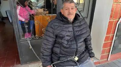 Se encadenó en la puerta del Ente Regulador y no se moverá hasta que lo atienda Saravia